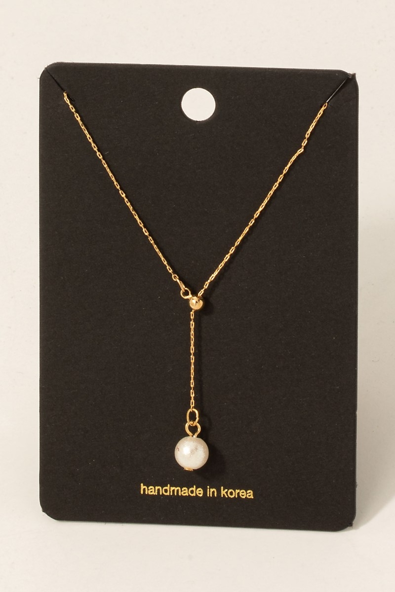 How can you tell if a pearl necklace is real?