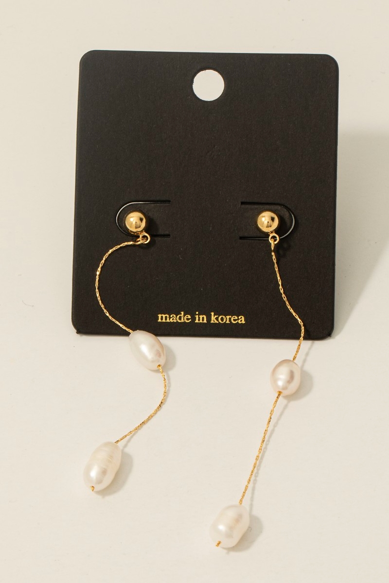 What is the significance of using freshwater pearls in these earrings?