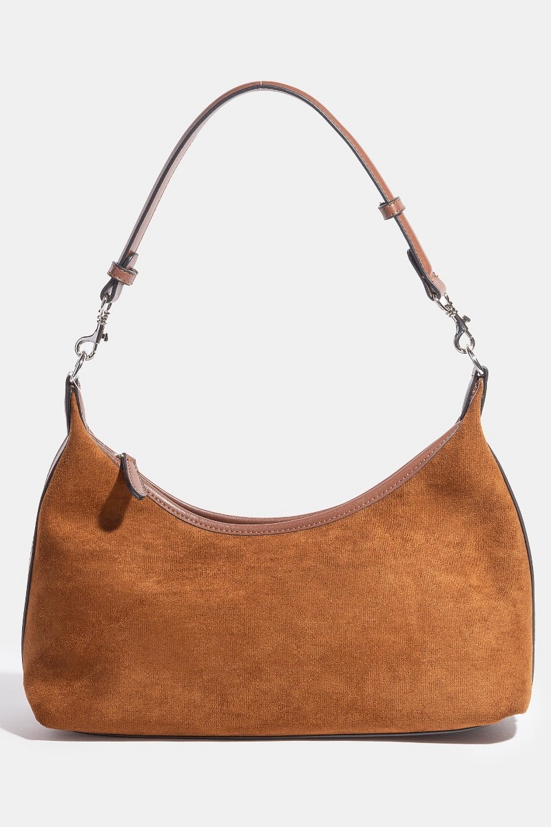 How does the hand bag enhance an ensemble?